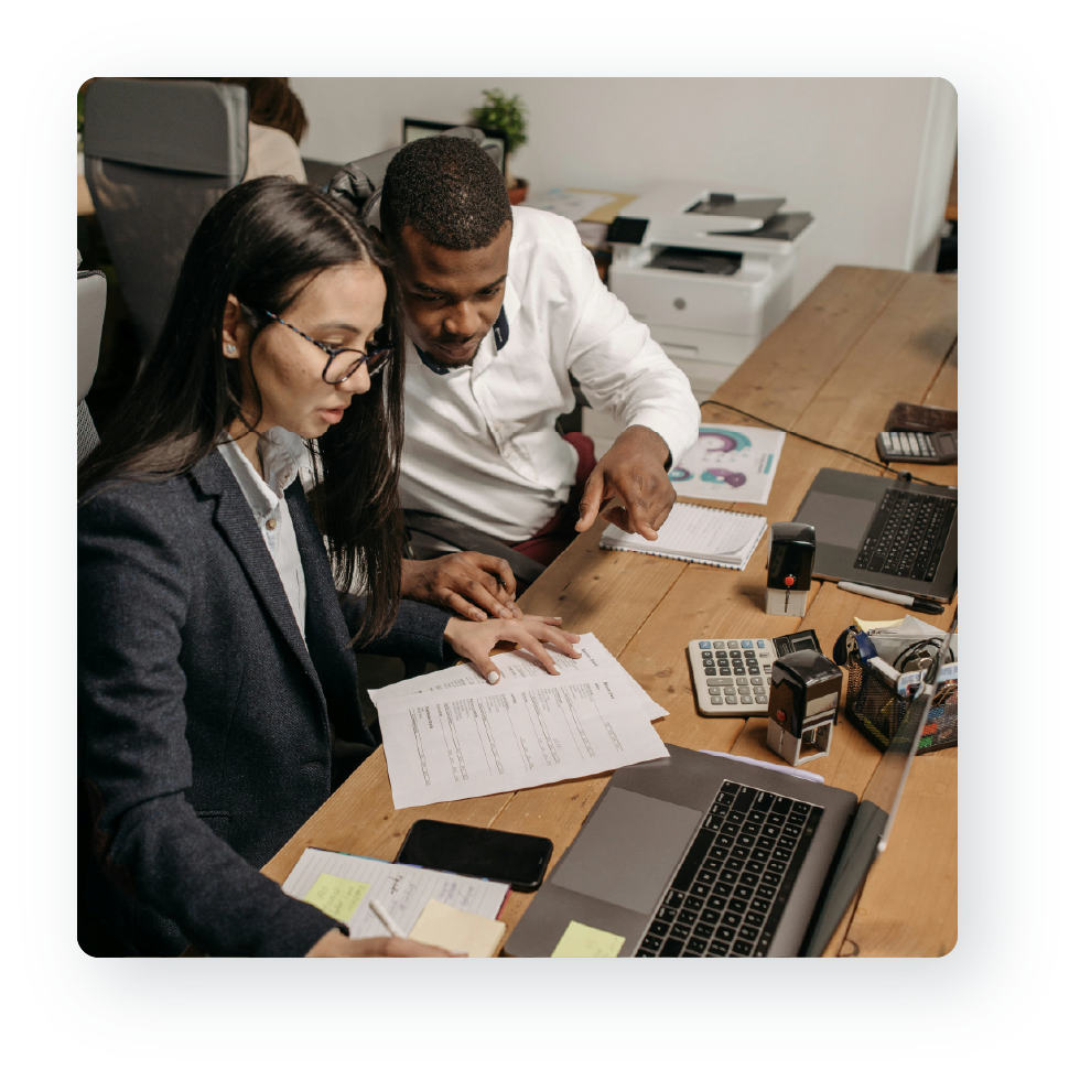 A professional assisting a client at a desk.