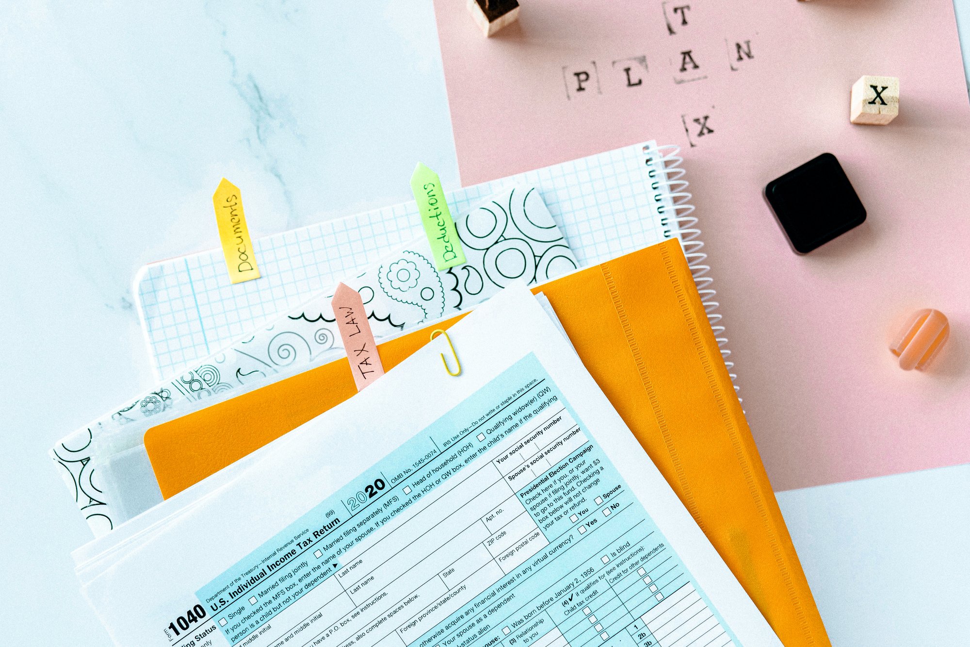 A stack of tax documents and notebooks.