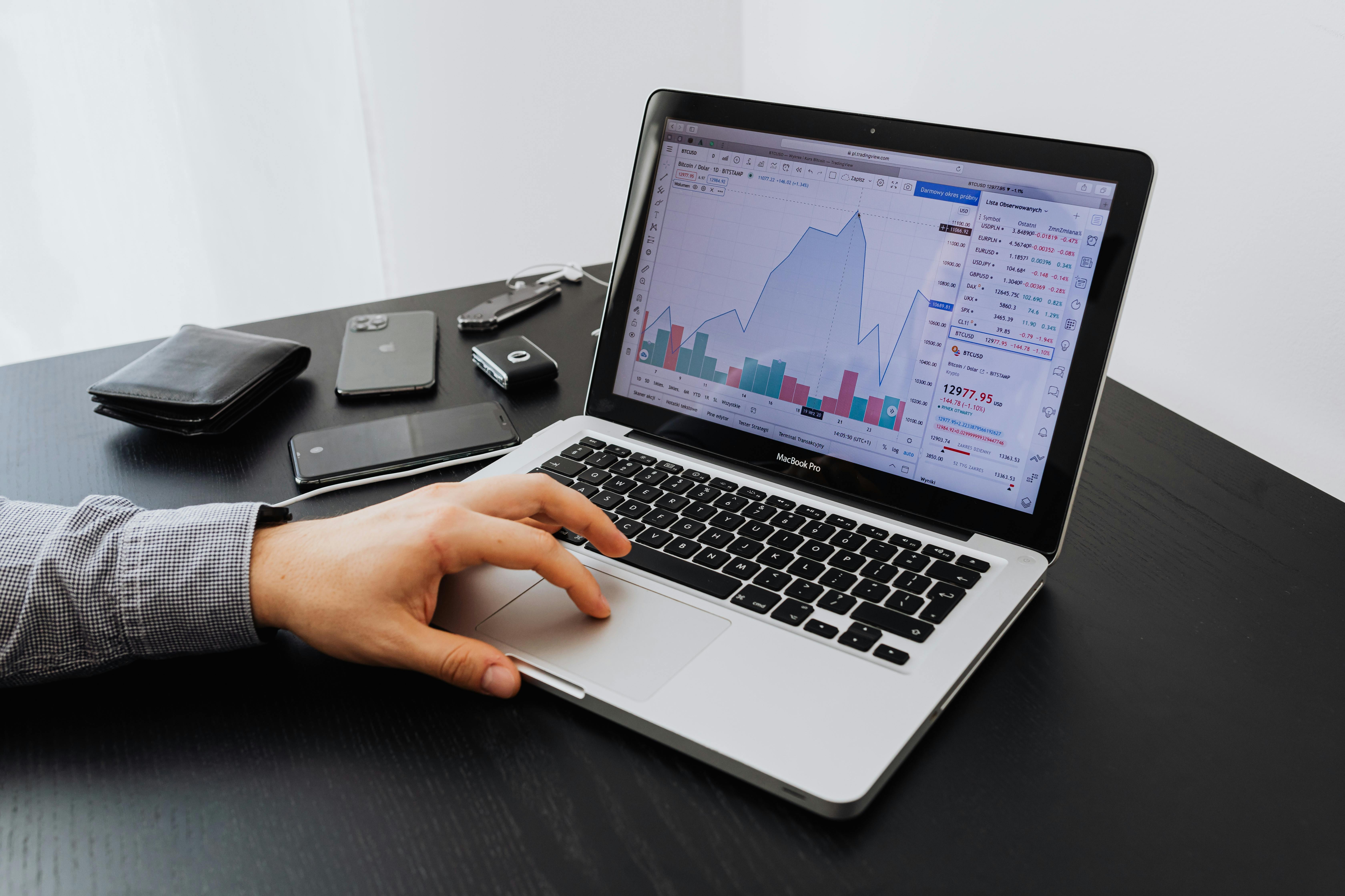 Business owner reviewing financial charts and data on a laptop — planning for QBI deduction and tax savings